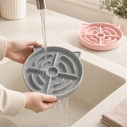 Gray Pace & Purr silicone slow feeder being rinsed clean