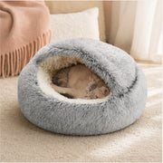 Small cat curled inside the HushHood plush cat cave