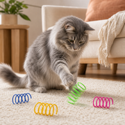Gray cat batting a green Spring Fling toy